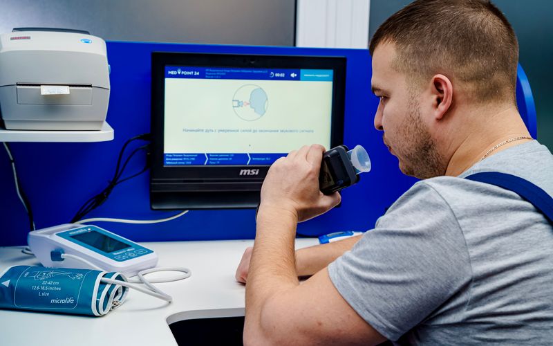 Man blowing into a breathalyzer device