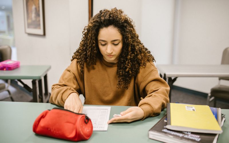 Student studying with a textbook and notes