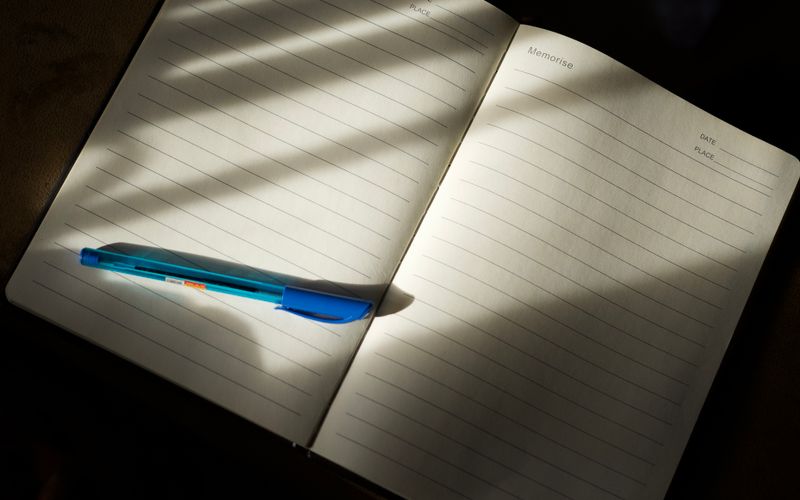 Open notebook with a pen for driver logs