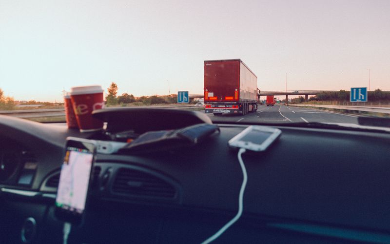 Highway view from the driver seat behind a semi truck