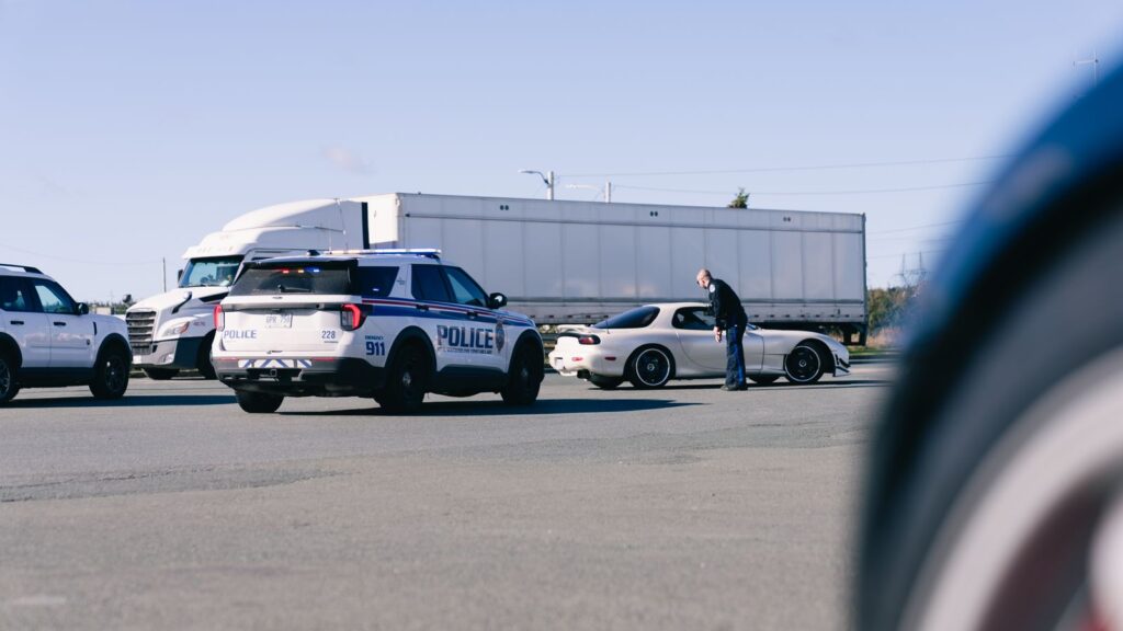 English proficiency out of service rule: inspector questioning a truck driver beside a semi during a roadside inspection