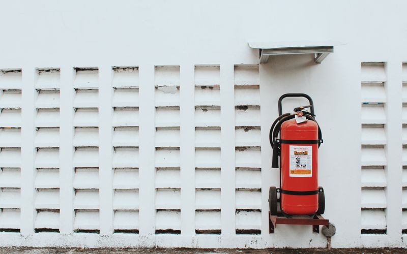 Red fire extinguisher mounted on a wall
