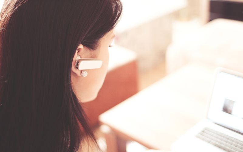 Person wearing a wireless Bluetooth headset